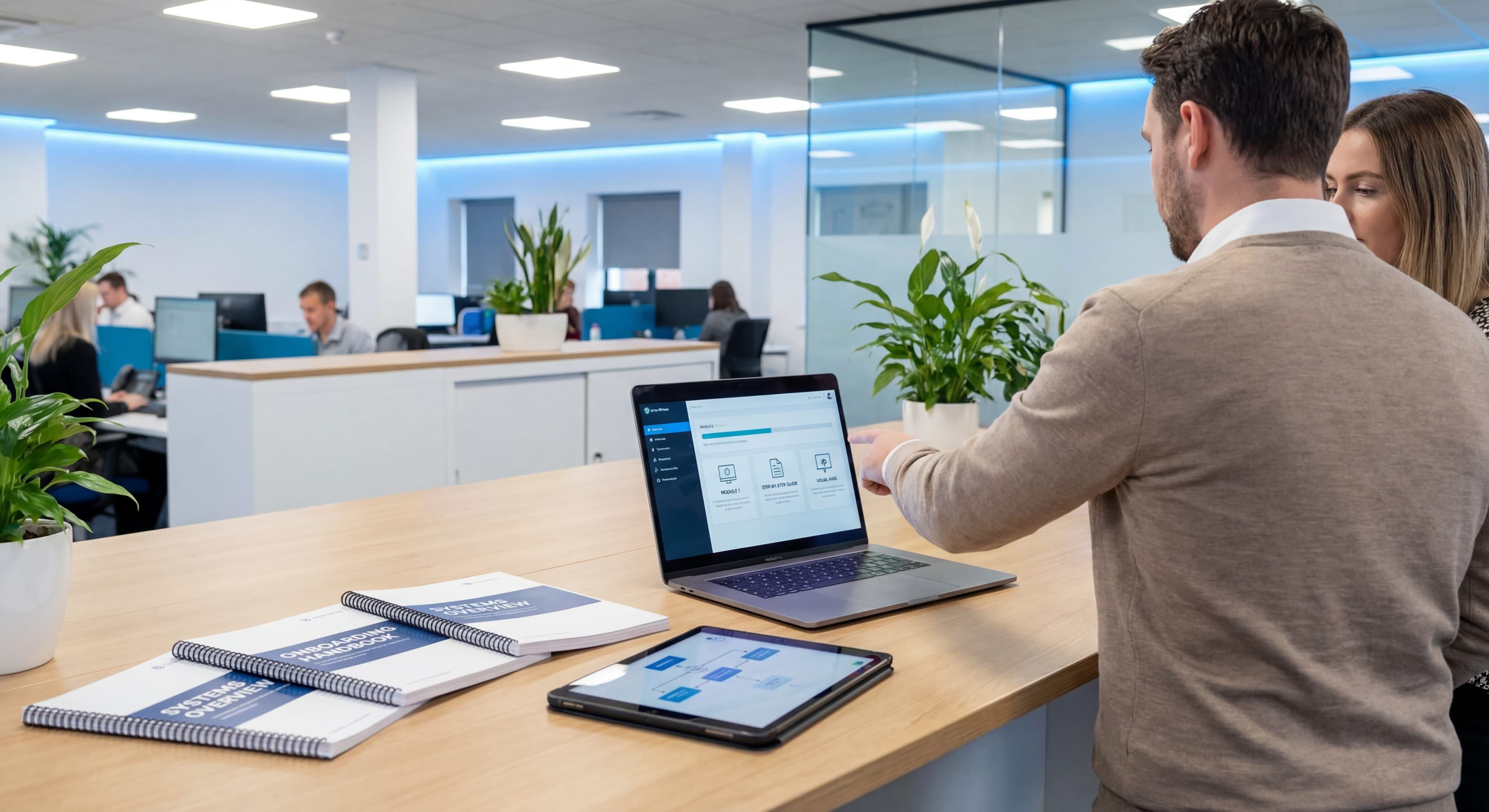 Professional creating employee training materials and educational content on laptop